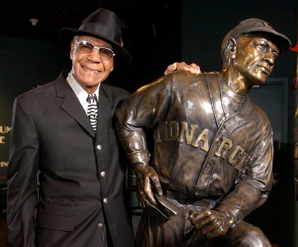 In this Feb. 11, 2005, file photo, Buck O'Neil stands with a statue of himself in the Negro League Baseball Museum in Kansas City, Mo. O'Neil, a champion of Black ballplayers during a monumental, eight-decade career on and off the field, has joined Gil Hodges, Minnie Minoso and three others in being elected to the baseball Hall of Fame, on Dec. 5, 2021. O'Neil, who died in 2006, will be inducted this year.