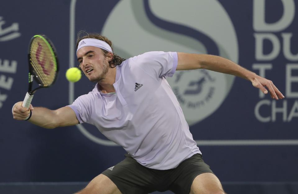 Stefanos Tsitsipas of Greece returns the ball to Great Britain's Daniel Evans during a semi final match of the Dubai Duty Free Tennis Championship in Dubai, United Arab Emirates, Friday, Feb. 28, 2020. (AP Photo/Kamran Jebreili)