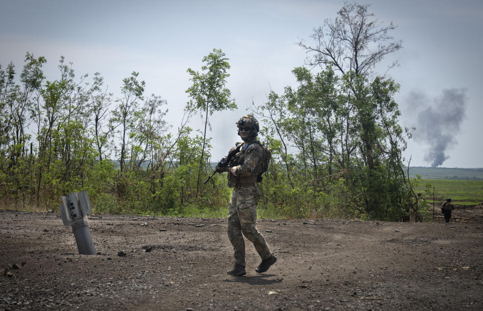 FILE - Ukrainian soldiers walk in their positions on the frontline in Zaporizhzhia region, Ukraine, Friday, June 23, 2023. In the southeastern Zaporizhzhia region, Ukrainian troops - backed by tanks, artillery and drones - have broken through initial Russian fighting positions and continue to make steady gains south of Velyka Novosilka near the administrative border with Donestk and south of Orikhiv, while confronting heavy bombardment in wide open fields with little cover. (AP Photo/Efrem Lukatsky, File)