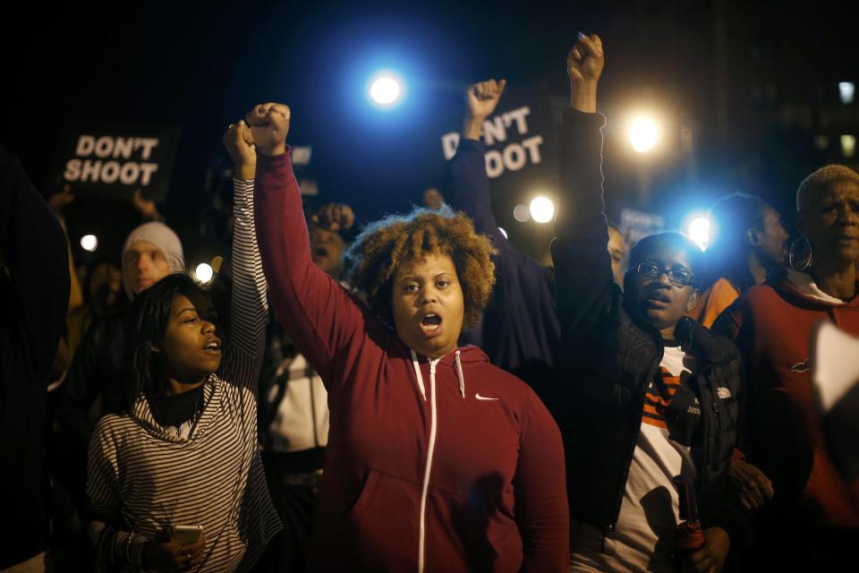 Protesters cheer after blocking an intersection after a vigil in St. Louis, Missouri, October 9, 2014. A 32-year-old white St. Louis police officer fatally shot 18-year-old Vonderrit Myers Jr. after the officer, who was off duty working for a private security company, saw Myers and two friends running and pursued them, according to a statement issued by the St. Louis police department. (REUTERS/Jim Young)