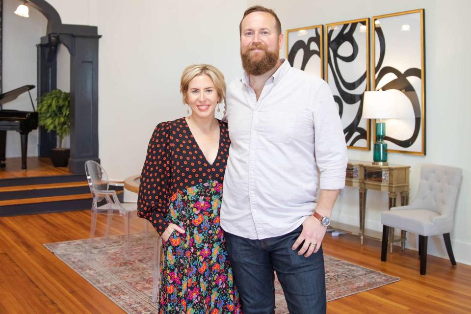 <p>Courtesy of HGTV</p> Erin and Ben pose in front of the custom oak cabinetry in the Fennell kitchen on reveal day.