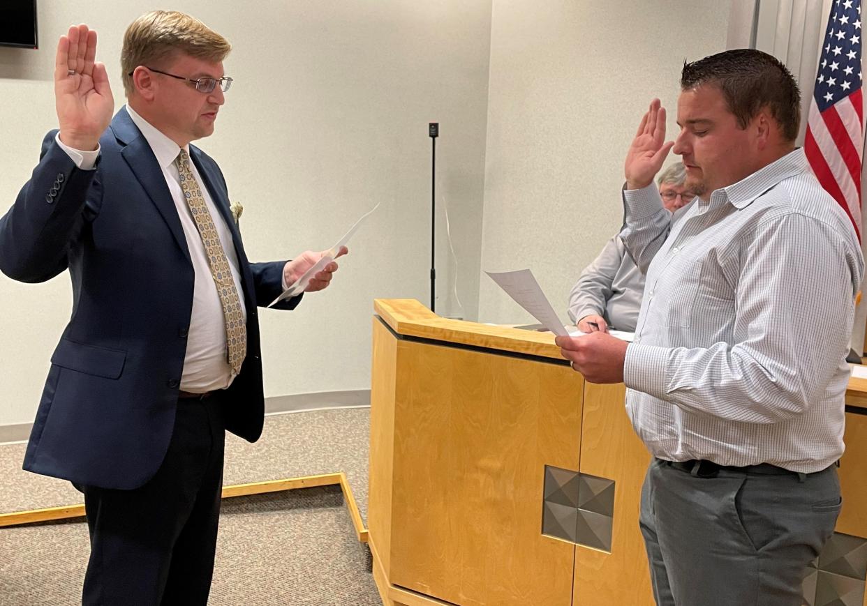 Tazewell County Clerk and Recorder of Deeds John Ackerman (left) swears in Michael Deppart as a District 1 representative on the Tazewell County Board.