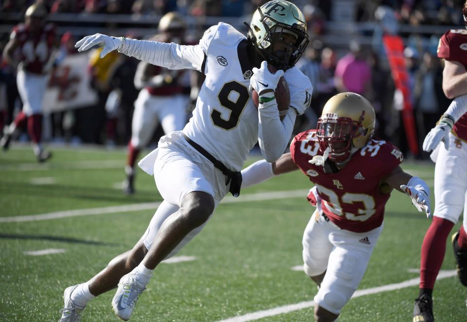 Demon Deacons wide receiver A.T. Perry runs the ball for a touchdown past Eagles defensive back Connor Grieco.