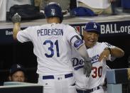 <p>Los Angeles Dodgers’ Joc Pederson is congratulated by manager Dave Roberts after hitting a home run during the fifth inning of Game 2 of baseball’s World Series against the Houston Astros Wednesday, Oct. 25, 2017, in Los Angeles. (AP Photo/Alex Gallardo) </p>