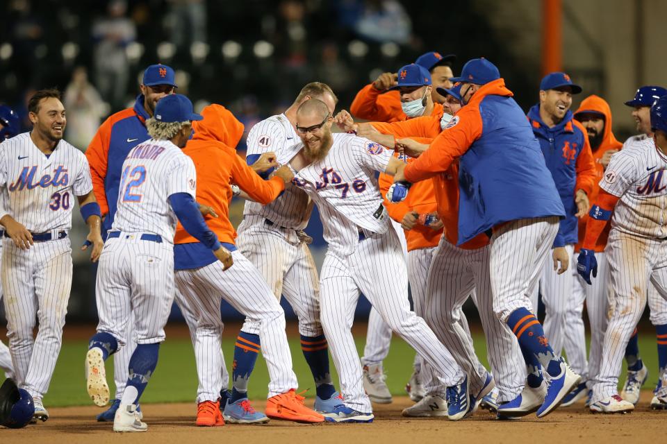 May 7, 2021; New York City, New York, USA; New York Mets pinch hitter Patrick Mazeika (76) celebrates with teammates after hitting a game winning RBI single against the Arizona Diamondbacks during the tenth inning at Citi Field. Mandatory Credit: Brad Penner-USA TODAY Sports