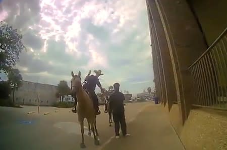 Galveston police officer Amanda Smith leads Donald Neely on horseback in Galveston