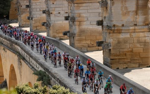 The peloton in action on the Pont du Gard - Credit: REUTERS