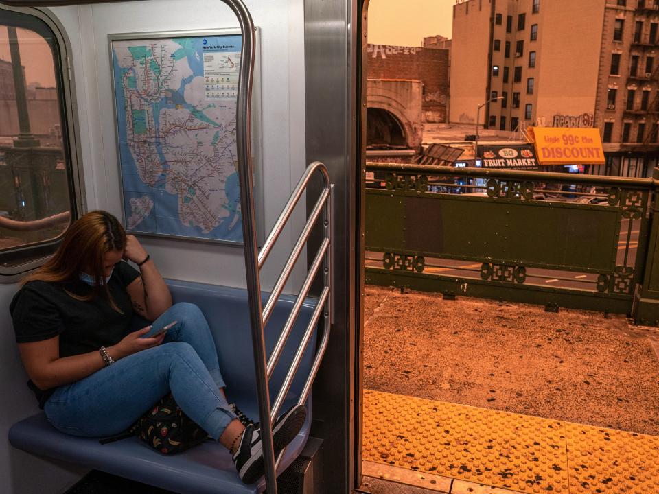 A person on the subway wears a fmask as smoky haze from wildfires in Canada blankets a neighborhood on June 7, 2023 in the Bronx borough of New York City. New York topped the list of most polluted major cities in the world on Tuesday night, as smoke from the fires continues to blanket the East Coast.