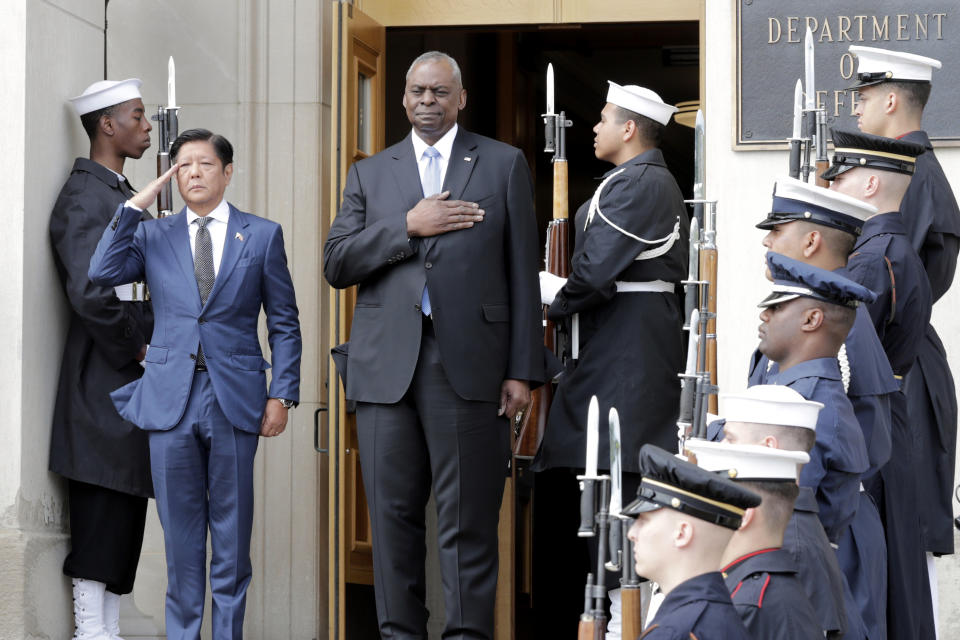 Secretary of Defense Lloyd Austin, right, and Philippines President Ferdinand Marcos Jr., left, stand during the American national anthem at an enhanced honor cordon ceremony at the Pentagon, Friday, April 12, 2024. (AP Photo/Luis M. Alvarez)