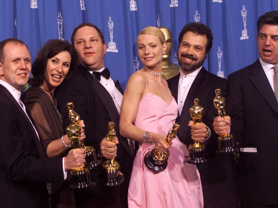 From left to right, David Parfitt, Donna Gigliotti, Harvey Weinstein, Gwyneth Paltrow, Edward Zwick and Marc Norman all celebrate after receiving the Oscar for best picture for "Shakespeare In Love" during the 71st Annual Academy Awards Sunday, March 21, 1999, at the Dorothy Chandler Pavilion of the Los Angeles Music Center. Paltrow won the Oscar for best actress in the movie.