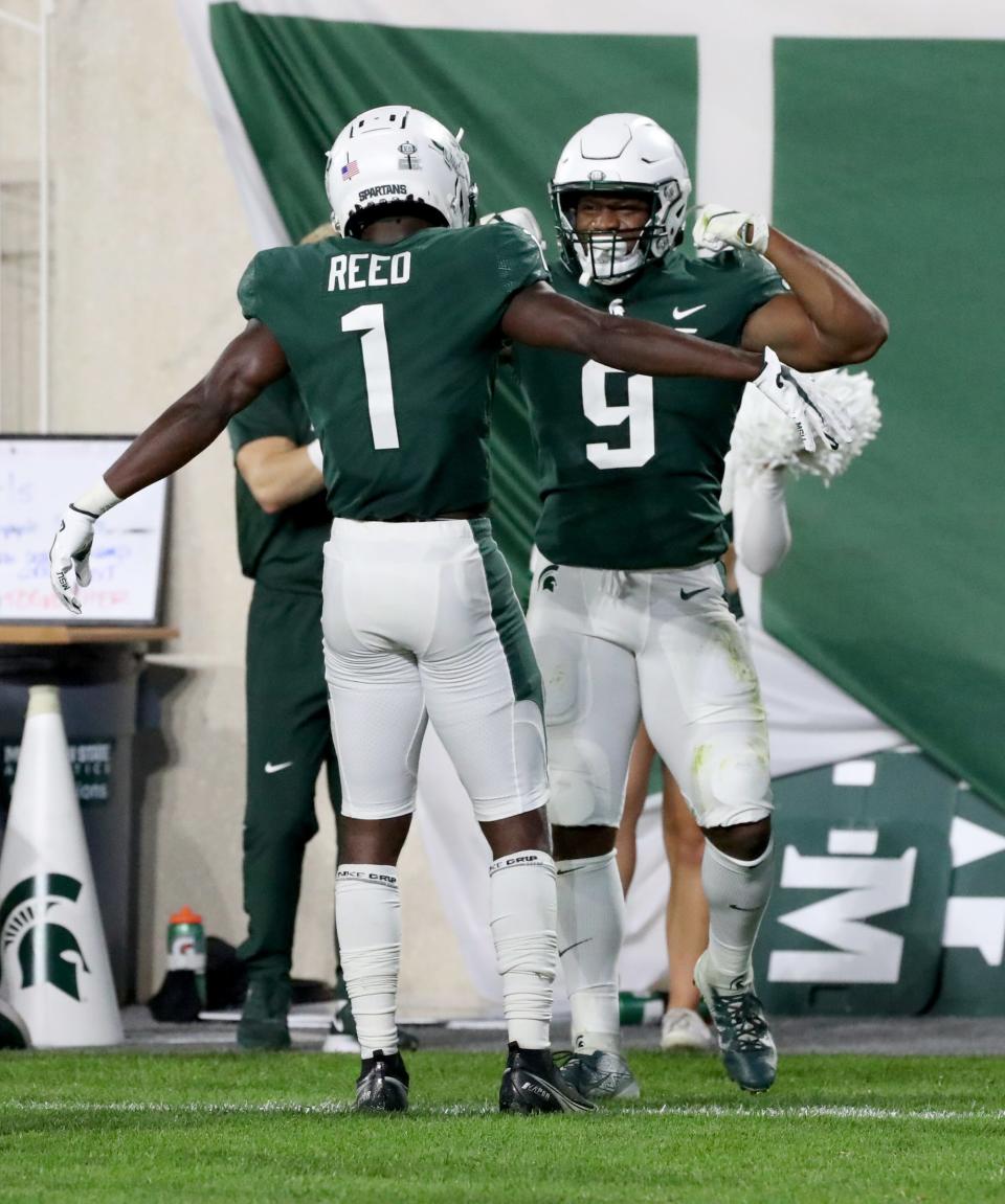 Michigan State Spartans wide receiver Jayden Reed (1) and running back Kenneth Walker III (9) celebrate after a touchdown against the Western Kentucky Hilltoppers Saturday, Oct. 02, 2021.