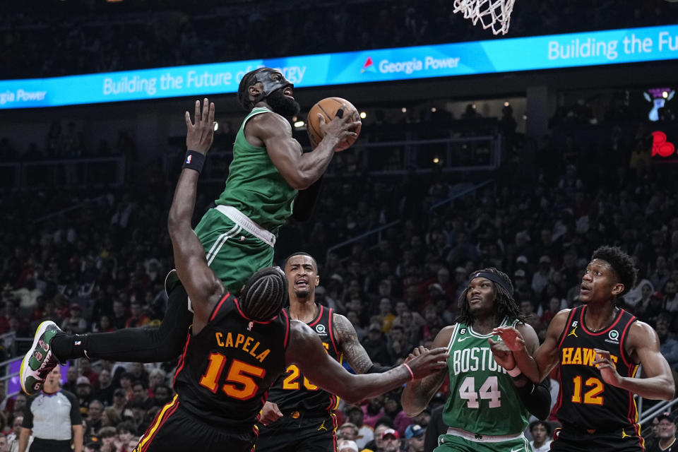 Boston Celtics' Jaylen Brown (7) fouls Atlanta Hawks' Clint Capela (15) while attempting to score during the first half of Game 6 of a first-round NBA basketball playoff series, Thursday, April 27, 2023, in Atlanta. (AP Photo/Brynn Anderson)