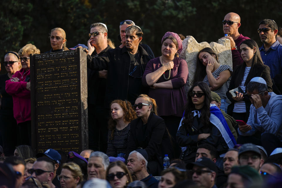 FILE - Mourners gather in grief around the grave of Israeli soldier Captain Harel Ittah during his funeral in Netanya, Israel, Sunday, Dec. 31, 2023. Ittah, 22, died of his wounds after he was injured while the army is battling Palestinian militants across Gaza in the war ignited by Hamas' Oct. 7 attack into Israel. (AP Photo/Ariel Schalit, File)