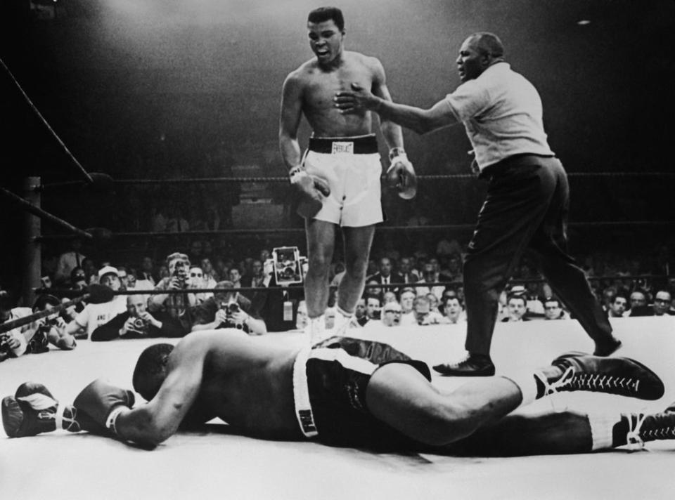 Sonny Liston lies out for the count as Muhammad Ali stands over him in 1965 (Getty)