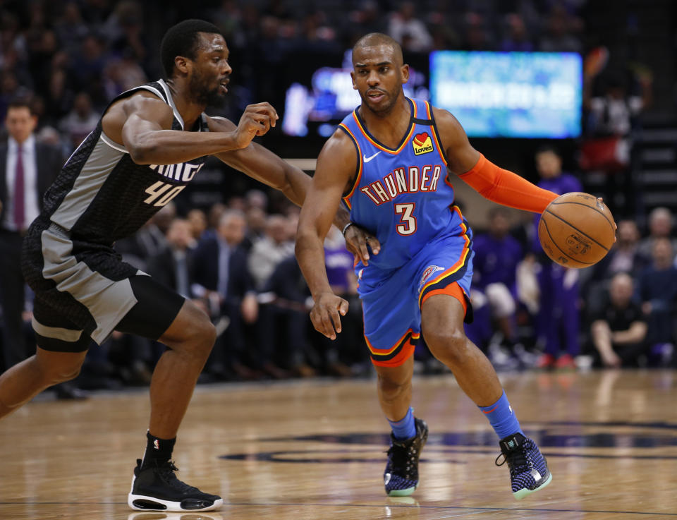 Oklahoma City Thunder guard Chris Paul, right, drive against Sacramento Kings forward Harrison Barnes, left, during the first quarter of an NBA basketball game in Sacramento, Calif., Wednesday, Jan. 29, 2020. (AP Photo/Rich Pedroncelli)