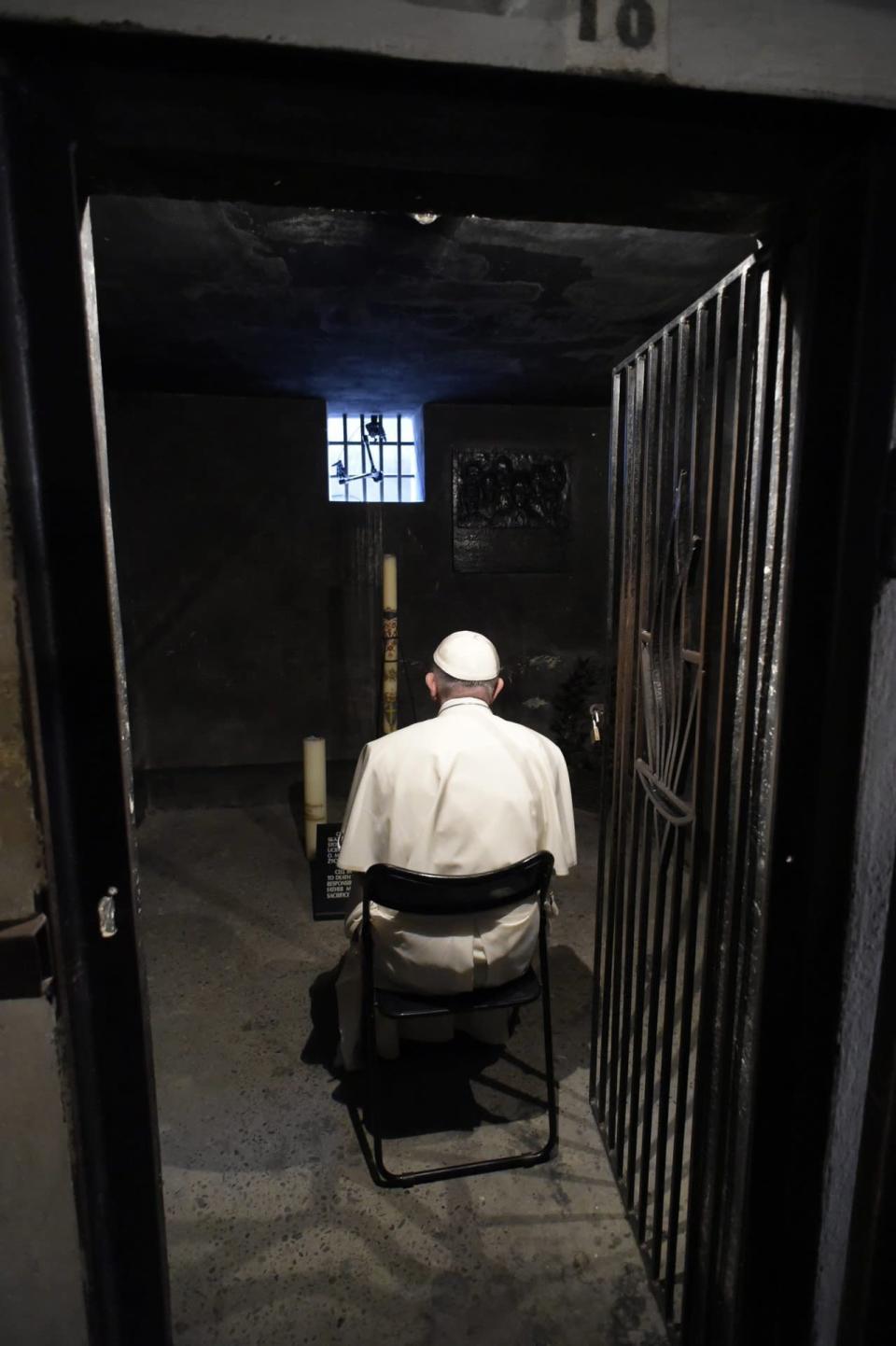 Pope Francis prays in the underground prison cell of a Catholic saint, Maximilian Kolbe, at the former Nazi German death camp of Auschwitz  in Oswiecim, Poland, Friday, July 29, 2016. Kolbe, a Polish Catholic friar, sacrificed his own life during the war to save the life of another man. (L'Osservatore Romano /Pool Photo via AP)