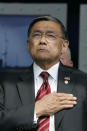 FILE - Transportation Secretary Norman Mineta puts his hand on his heart during the playing of the national anthem before President George W. Bush addresses the graduating class of the U.S. Merchant Marine Academy in Kings Point, N.Y., June 19, 2006. Mineta, who broke racial barriers for Asian Americans serving in high-profile government posts and ordered commercial flights grounded after the 9/11 terror attacks as the nation's federal transportation secretary, died Tuesday, May 3, 2022. He was 90. (AP Photo/Charles Dharapak, File)