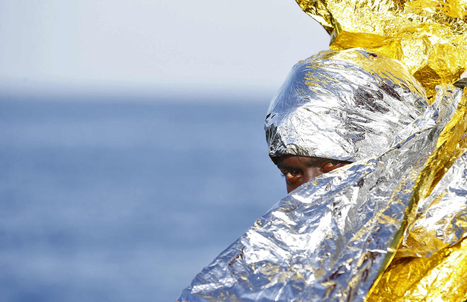 A migrant waits to disembark from the rescue vessel