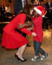 <p>Kate Middleton hugs a young boy in a Santa hat during the Anna Freud Centre Family School Christmas Party.</p>