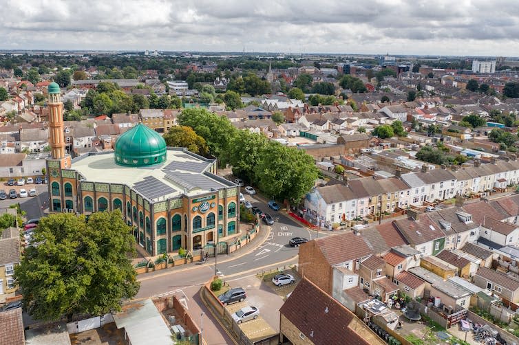 An aerial view of a mosque in a city centre.