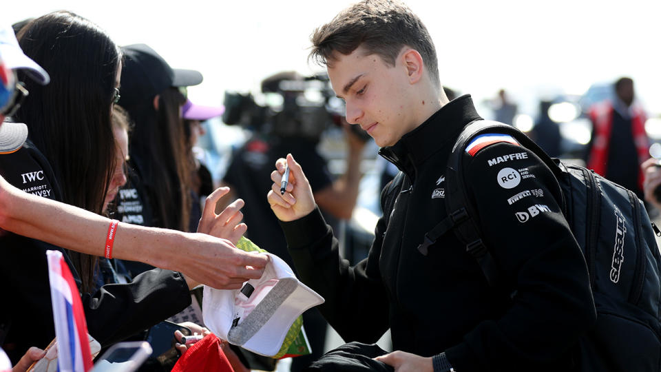 Oscar Piastri signs autographs for F1 fans.