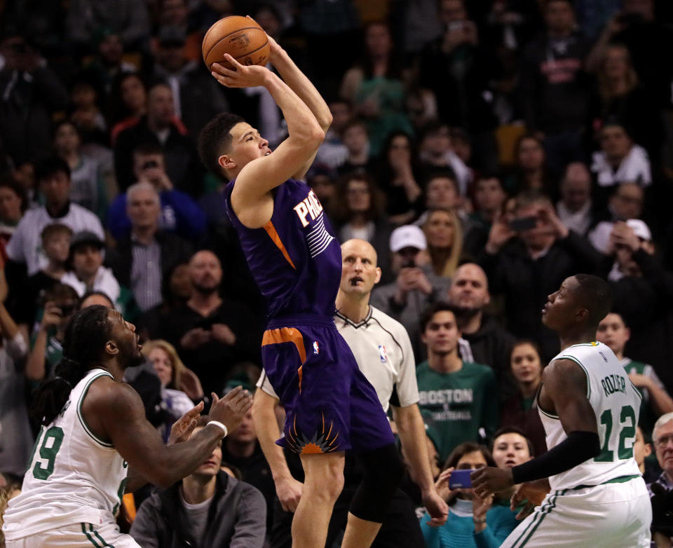 Phoenix Suns guard Devin Booker puts up a shot during his 70-point game against the Boston Celtics on March 24, 2017. (Barry Chin/The Boston Globe via Getty Images)