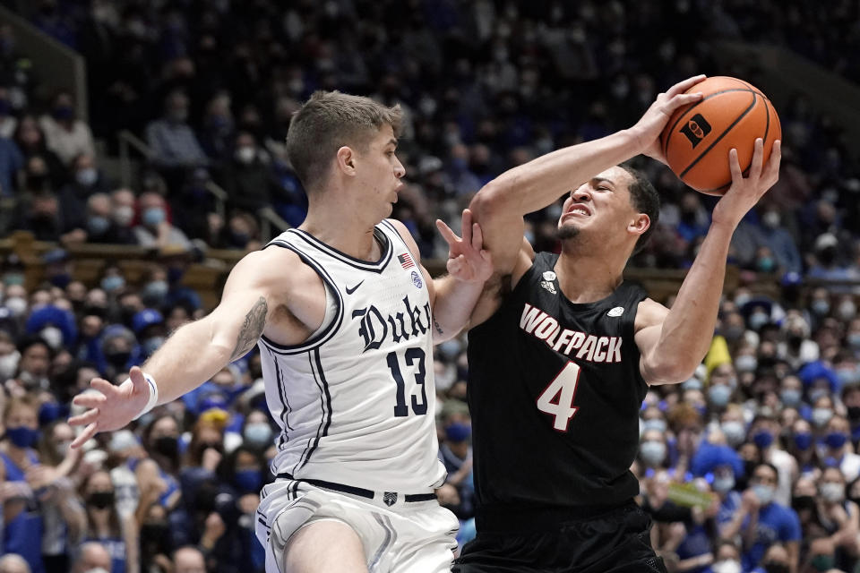 Duke forward Joey Baker (13) guards North Carolina State forward Jericole Hellems (4) during the first half of an NCAA college basketball game in Durham, N.C., Saturday, Jan. 15, 2022. (AP Photo/Gerry Broome)