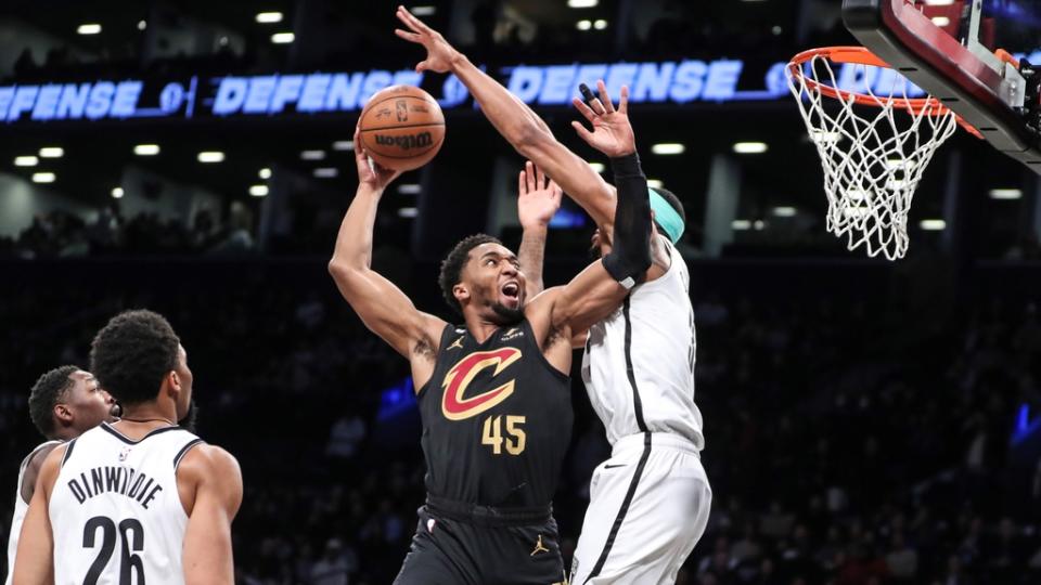 Mar 23, 2023; Brooklyn, New York, USA; Cleveland Cavaliers guard Donovan Mitchell (45) goes up against Brooklyn Nets center Nic Claxton (33) in the first quarter at Barclays Center. Mandatory Credit: Wendell Cruz-USA TODAY Sports