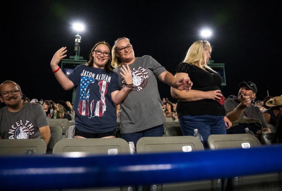 Madison Banta, 14, left, and her mother, Carisa Canada, of Citrus Heights, dance along to music by the D.J. between sets at Jason Aldean’s Highway Desperado tour concert Thursday, Sept. 21, 2023, at Toyota Amphitheatre in Yuba County.