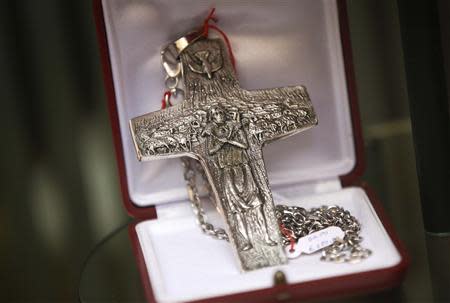 A cardinal cross shaping the one used by Pope Francis is seen on display at the window of the Gammarelli tailor shop in Rome February 11, 2014. REUTERS/Max Rossi
