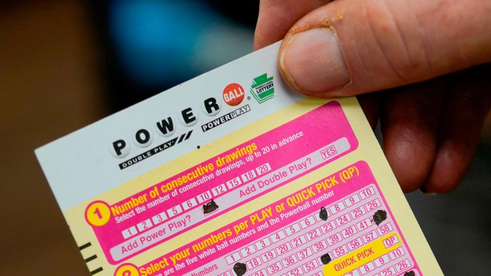 PHOTO: In  this Nov. 7, 2022 file photo a person shows their scan card for their personal selection numbers for a ticket for a Powerball drawing at a convenience store in Renfrew, Pa (Keith Srakocic/AP, FILE)