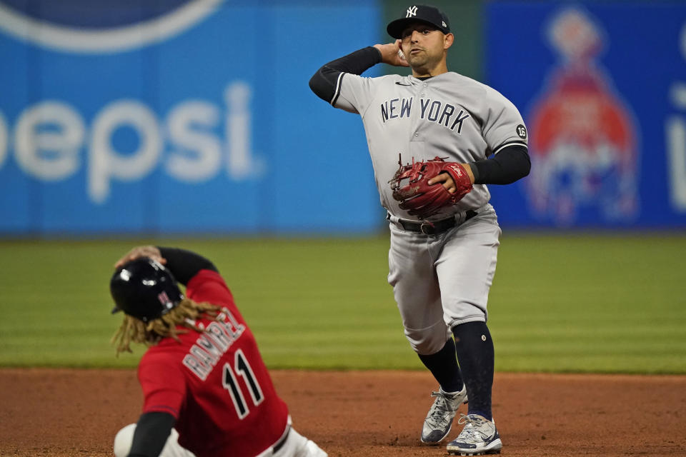 New York Yankees' Rougned Odor, right, throws to first base after getting Cleveland Indians' Jose Ramirez out at second base during the eighth inning of a baseball game, Friday, April 23, 2021, in Cleveland. Franmil Reyes was out at first base for the double play. (AP Photo/Tony Dejak)