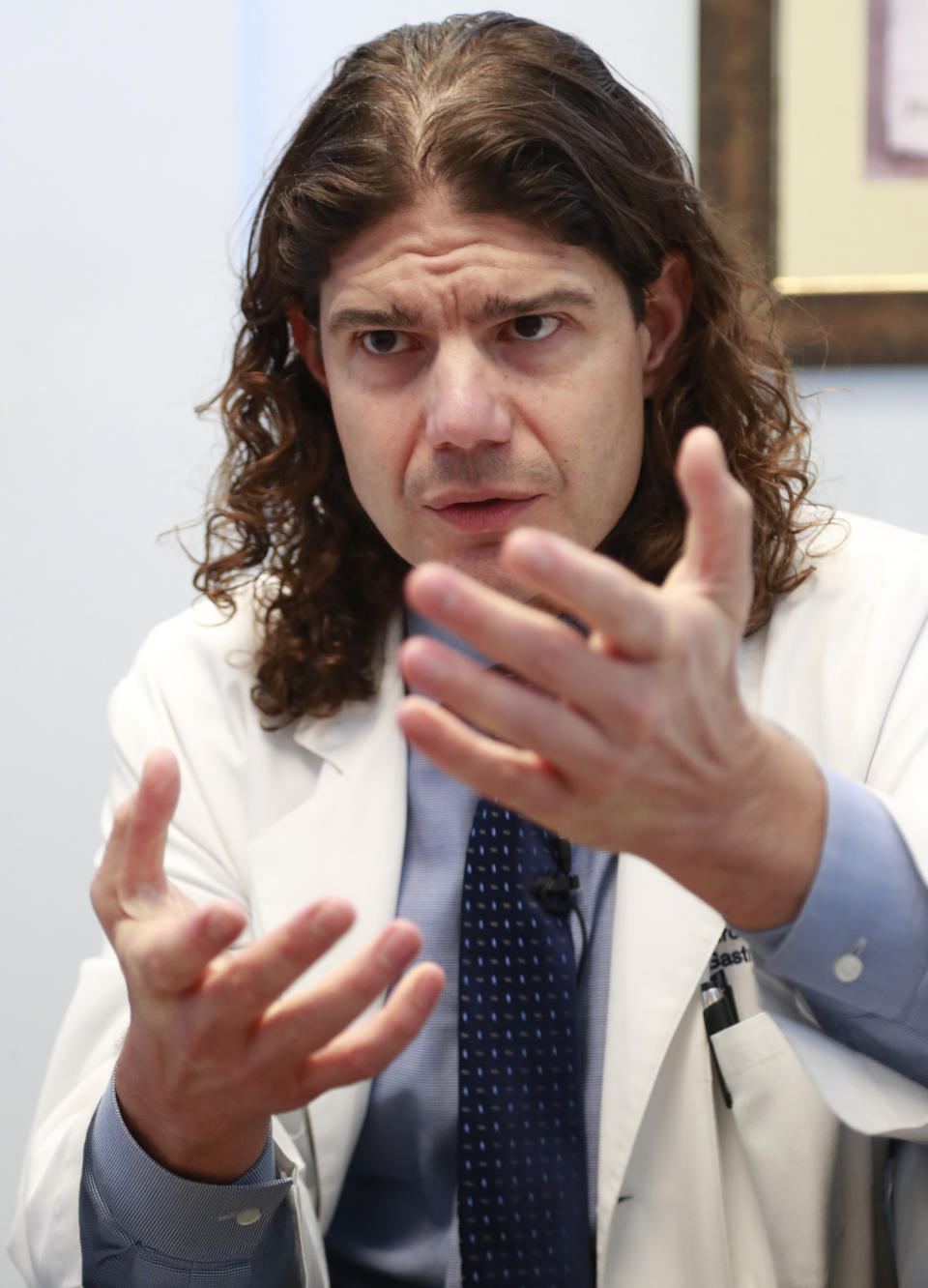 In this Feb. 15, 2019 photo, Venezuelan Pedro Morales, a gastroenterologist who has lived in Miami for over two decades, speaks during an interview in Miami. Even those who left long ago have begun imagining how they might contribute to Venezuela's recovery. "I want to put in my little grain of sand," said Morales. (AP Photo/Wilfredo Lee)