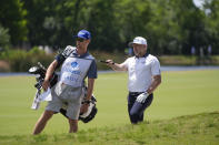 David Skinns, of England, discusses his shot with his caddie on the 18th fairway during the second round of the PGA Zurich Classic golf tournament at TPC Louisiana in Avondale, La., Friday, April 26, 2024. (AP Photo/Gerald Herbert)