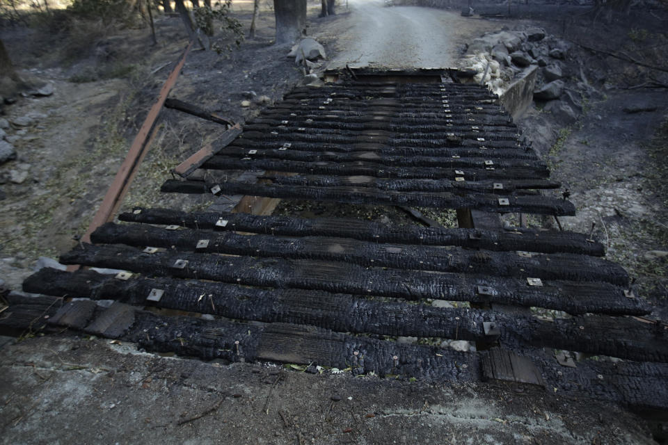 A destroyed bridge leads to a driveway of a property charred in the Kincade Fire near Healdsburg, Calif., Thursday, Oct. 31, 2019. (AP Photo/Charlie Riedel)