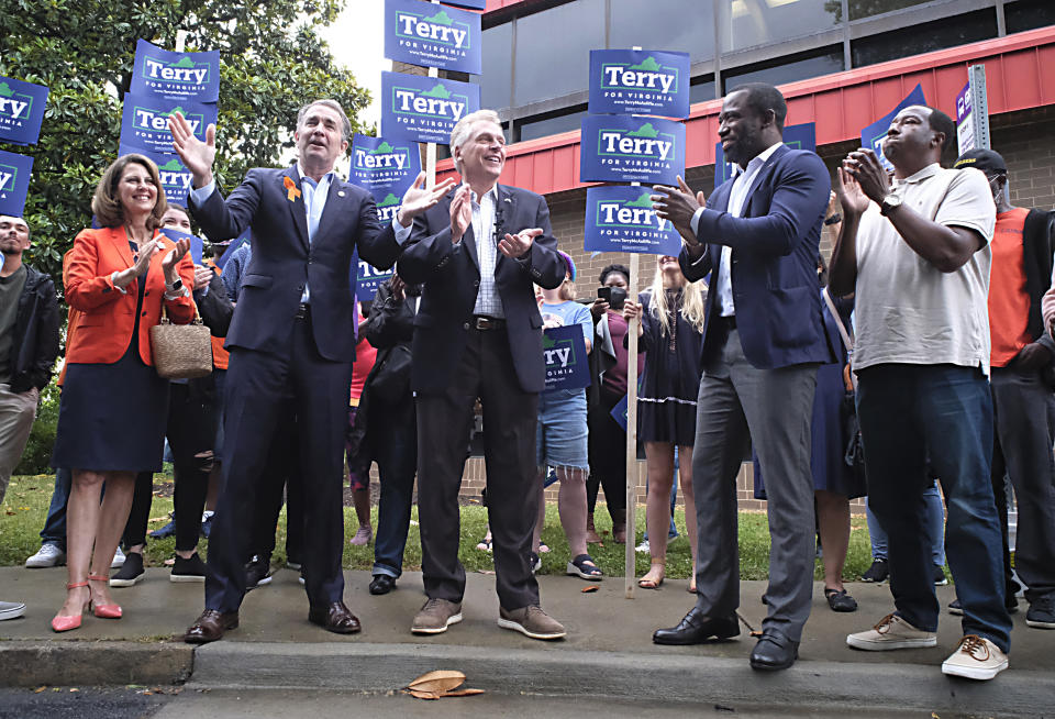 Virginia Governor Ralph Northam, second from left, talks about his endorsement in the Democratic gubernatorial primary of former governor Terry McAuliffe, third from left, during a quick rally outside the Office of the General Registrar, City of Richmond, in Richmond, Va. Friday, June 4, 2021. (Bob Brown/Richmond Times-Dispatch via AP)