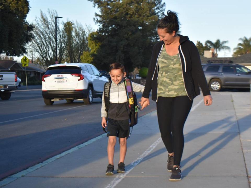 First-grader Ryder Bussell walks with his mom, Kasha, at Sherwood Elementary School in Modesto on Monday, March 14, 2022.