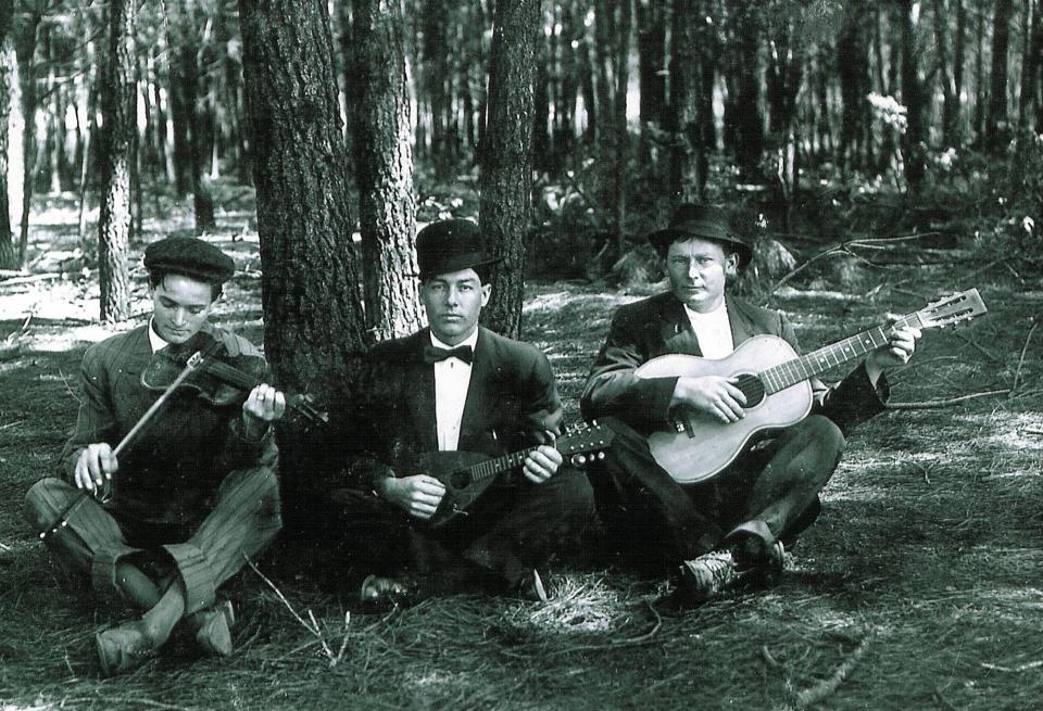 In this undated photo from the collection of Patrick Lernout, American World War One soldier Wesley Creech, center, plays an instrument along with two family members in Bolton, North Carolina. As if by premonition, Private Wesley Creech no longer hid the darkness of his soul from his wife Carzetta and five-month-old daughter Marie during the decisive weeks of World War One. “If I never see you and Marie any more, I hope to meet you in a Better Place,” he penned down in his best strokes on Aug. 24, 1918, when the American army was pushing the Germans back in Belgium. He signed off the letter with “good By.” One week later he was killed by an enemy bullet in the head. (AP Photo)