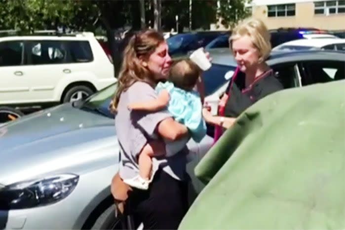 Reunited: mum and daughter embrace as the toddler is successfully freed from the hot car. Photo: 7 News.