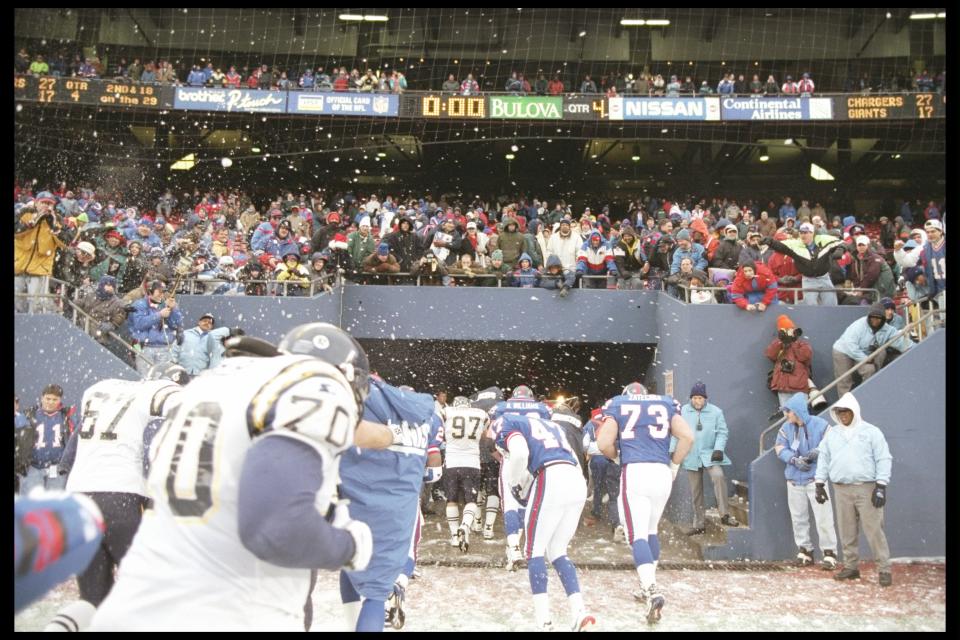 Players on both the New York Giants and the San Diego Chargers try to avoid snowball thrown by fans at Giants Stadium in 1995. (AP)