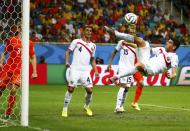 Costa Rica's Johnny Acosta (R) attempts an overhead kick to clear the ball from the penalty box during a Netherlands corner during their 2014 World Cup quarter-finals at the Fonte Nova arena in Salvador July 5, 2014. REUTERS/Paul Hanna