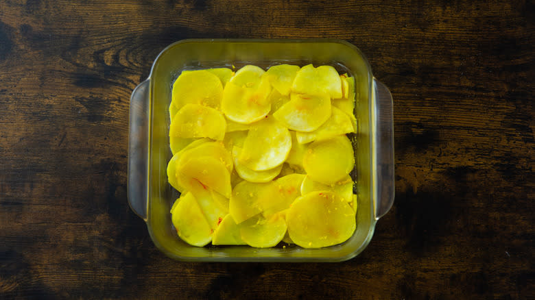 turnip slices layered in a pan 