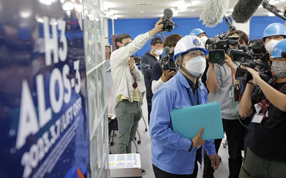 A JAXA public relations officer explains the launch failure to reporters - KYODO/REUTERS