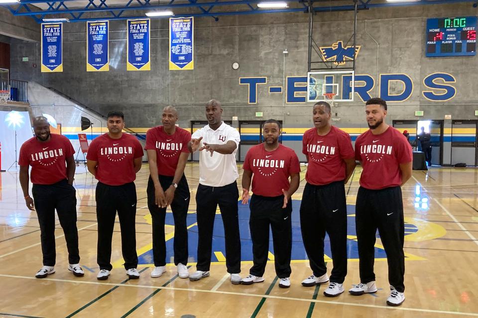 Gary Payton, middle, gestures while posing for photos in 2021 with assistant coaches during his first season with the Lincoln University men's basketball team.