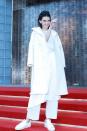 <p>Jenner’s red carpet outfit at the Ports 1961 presentation in Shanghai consisted of crisp white layers: A long tunic top belted over trousers, topped off with a long coat covered in pompoms from the brand’s <a href="http://www.vogue.com/fashion-shows/fall-2015-ready-to-wear/ports-1961/slideshow/collection#27" rel="nofollow noopener" target="_blank" data-ylk="slk:Fall 2015 collection;elm:context_link;itc:0;sec:content-canvas" class="link ">Fall 2015 collection</a>. She finished her outfit with bright white sneakers. It’s a super fresh, monochrome look for the 19-year-old model. There’s no doubt her brother-in-law Kanye West would approve. </p>