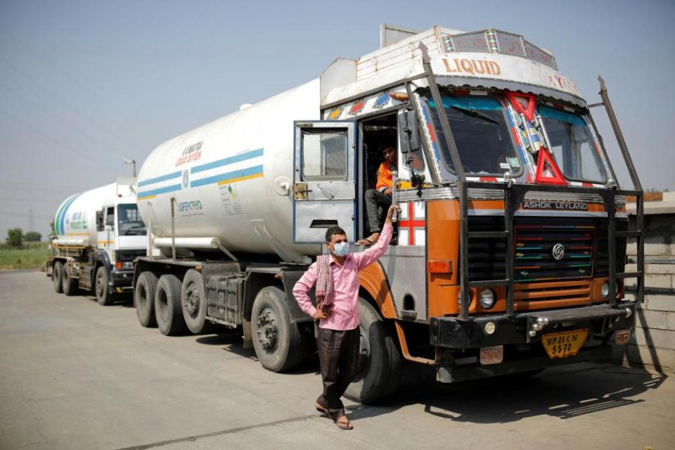 A driver stands next to an empty tanker as he waits for his turn to fill liquid oxygen, to be transported to a COVID-19 hospital on the outskirts of New Delhi, India, April 22