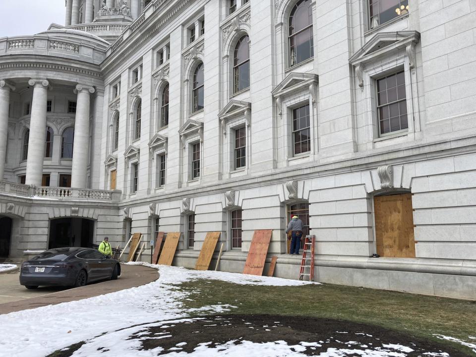 Workers begin boarding up the Wisconsin state Capitol building in Madison on January 11, 2021. State officials are concerned about the prospects of state-centered violence in the wake of last week's security breaches at the U.S. Capitol. / Credit: Todd Richmond / AP