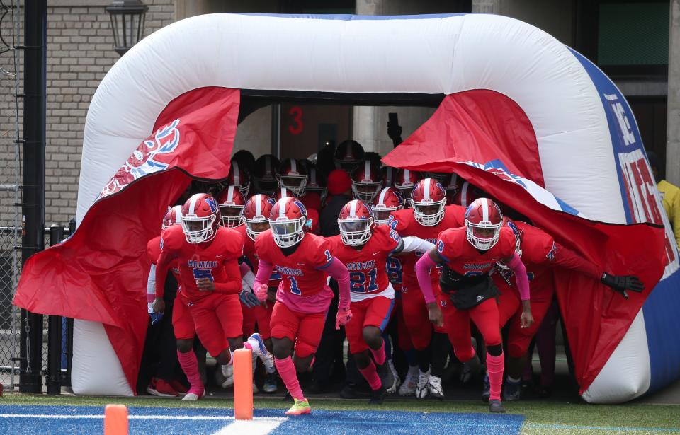 The Monroe Red Jackets race onto the field to face Honeoye Falls-Lima at the start of their game Saturday, Oct. 8, 2022 at James Monroe High School in Rochester. 