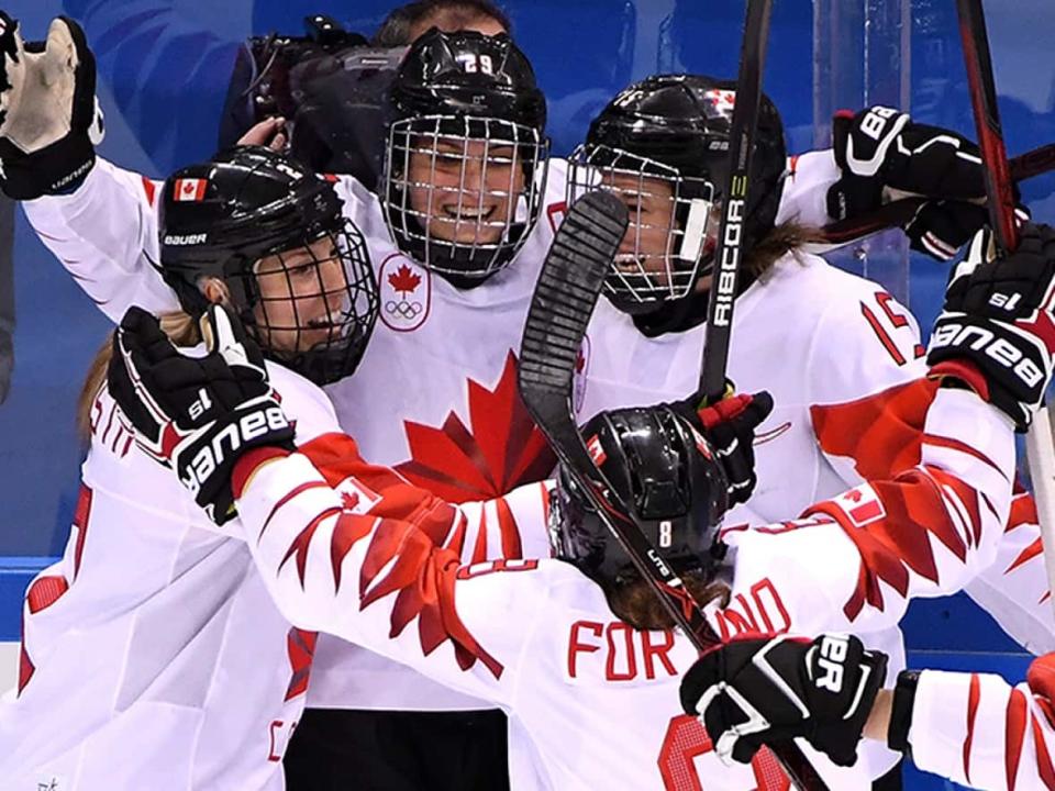 Team captain Marie-Philip Poulin, second from left, will lead Canada’s women’s hockey team at the Beijing Olympics in February. The Canadians will aim for their fifth gold medal overall and first since 2014. (Harry How/Getty Images/File - image credit)