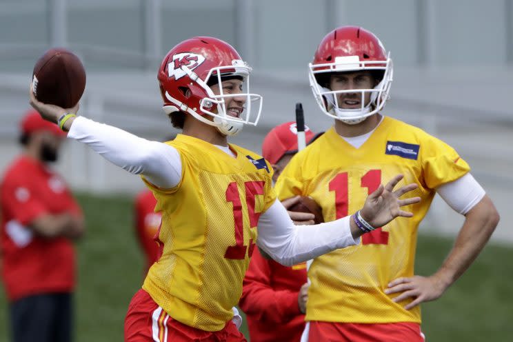 Patrick Mahomes (15) throws as Alex Smith looks on. (AP)